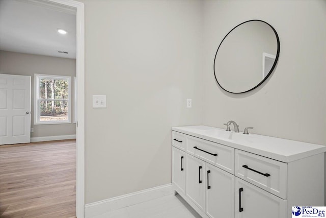 bathroom featuring vanity and wood-type flooring