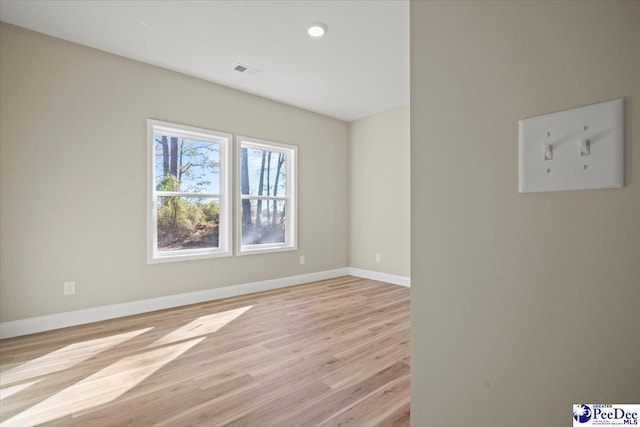 unfurnished room with light wood-type flooring