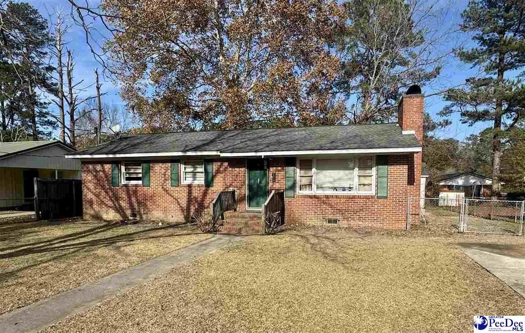 single story home with crawl space, a chimney, fence, and brick siding