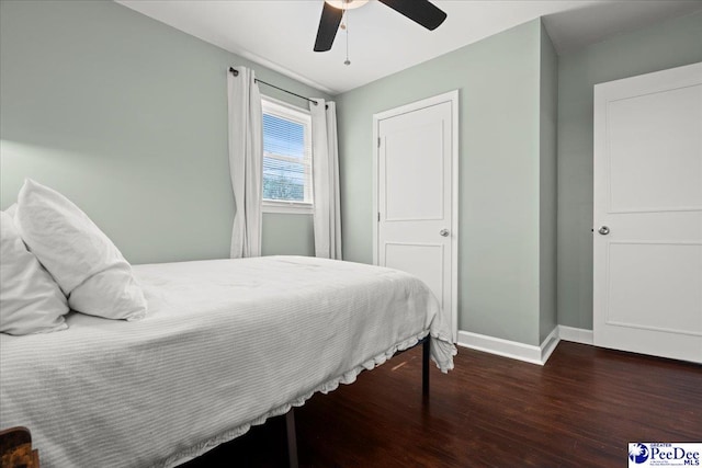 bedroom with a ceiling fan, wood finished floors, and baseboards