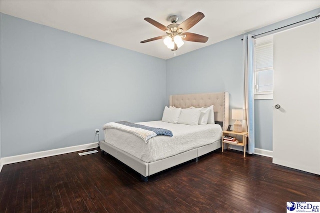 bedroom featuring baseboards, wood-type flooring, and a ceiling fan