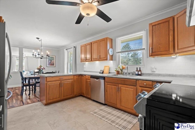 kitchen with a sink, stainless steel appliances, a peninsula, crown molding, and light countertops