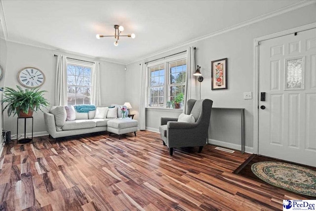 living area featuring crown molding, baseboards, and wood finished floors