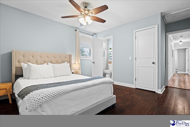 bedroom with baseboards, attic access, ceiling fan, ensuite bathroom, and wood-type flooring