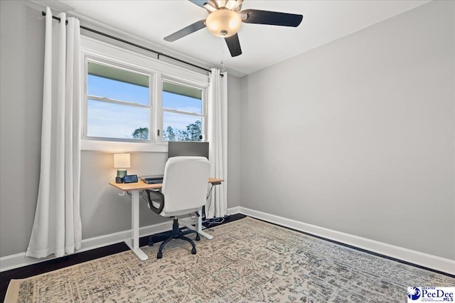 office featuring baseboards and ceiling fan