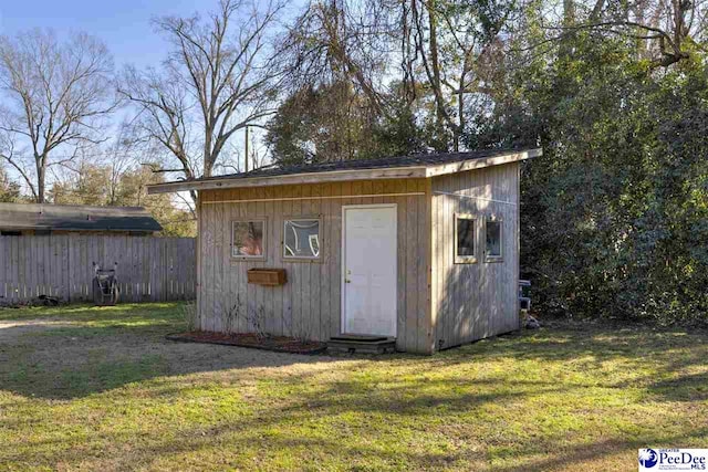 view of shed featuring fence