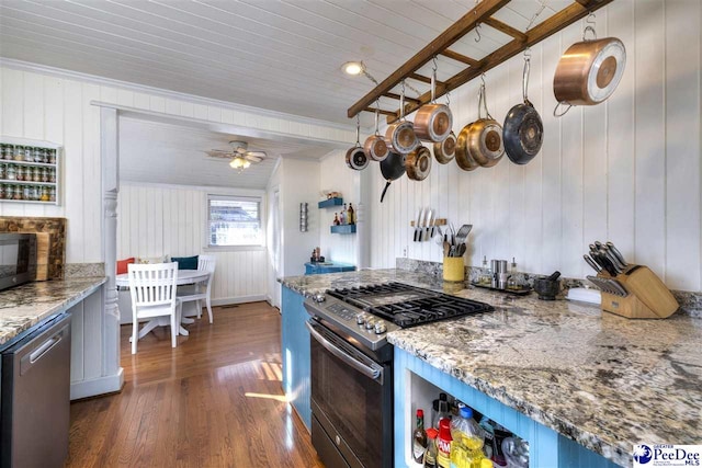 kitchen with light stone counters, dark wood-type flooring, a ceiling fan, stainless steel dishwasher, and gas range oven