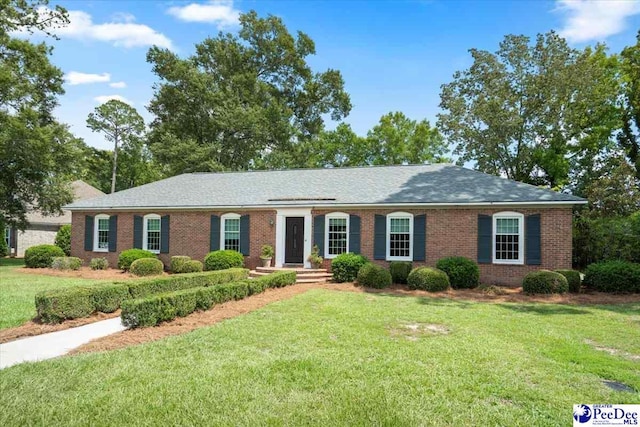 ranch-style home featuring a front yard