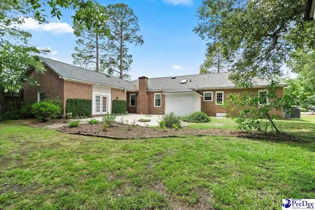 rear view of house featuring a yard and a patio area