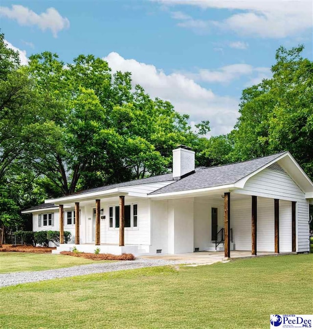 306 Mimosa Dr, Cheraw, SC 29520 - view of front of house featuring covered porch, a front yard, a chimney, roof with shingles, and stucco siding