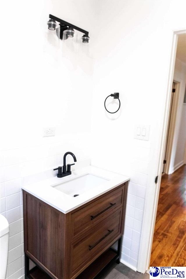 306 Mimosa Dr, Cheraw, SC 29520 - half bath with vanity, tile walls, and wood finished floors