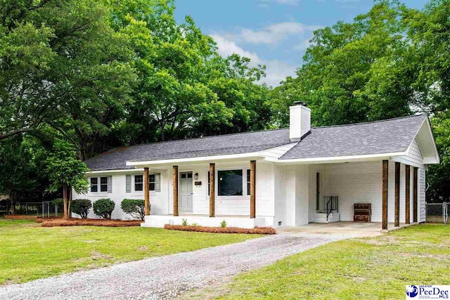306 Mimosa Dr, Cheraw, SC 29520 - single story home with asphalt driveway, a carport, a shingled roof, and a chimney