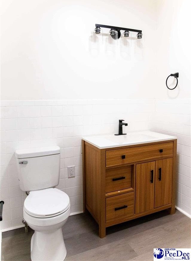 306 Mimosa Dr, Cheraw, SC 29520 - bathroom with tile walls, vanity, and wood finished floors