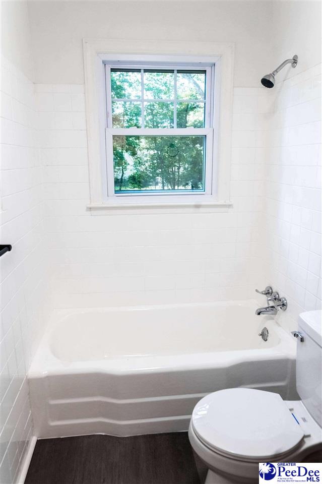 306 Mimosa Dr, Cheraw, SC 29520 - full bathroom with tub / shower combination and wood finished floors