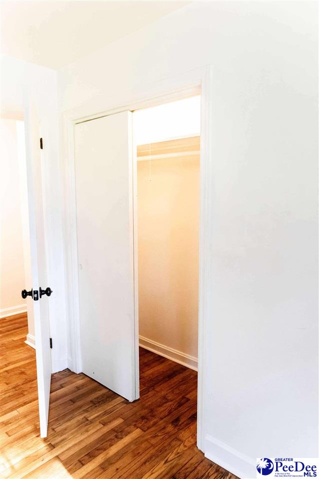 306 Mimosa Dr, Cheraw, SC 29520 - unfurnished bedroom featuring a closet and wood finished floors