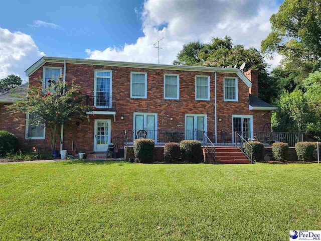 129 Golf Course Rd, Hartsville, SC 29550 - view of front facade featuring a front lawn, a chimney, and brick siding