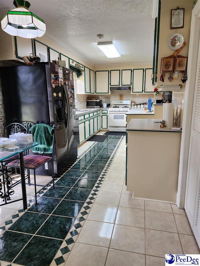 129 Golf Course Rd, Hartsville, SC 29550 - kitchen with white gas range oven, refrigerator with ice dispenser, a textured ceiling, under cabinet range hood, and stainless steel microwave