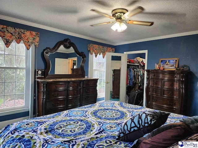 129 Golf Course Rd, Hartsville, SC 29550 - bedroom featuring a textured ceiling, ornamental molding, a walk in closet, ceiling fan, and a closet
