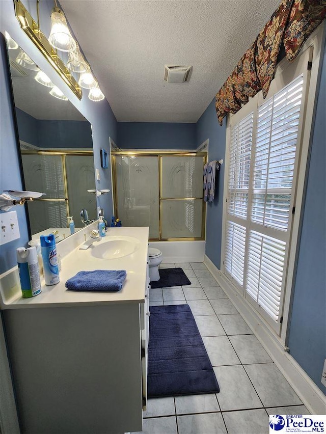 129 Golf Course Rd, Hartsville, SC 29550 - bathroom with toilet, vanity, healthy amount of natural light, a textured ceiling, and combined bath / shower with glass door