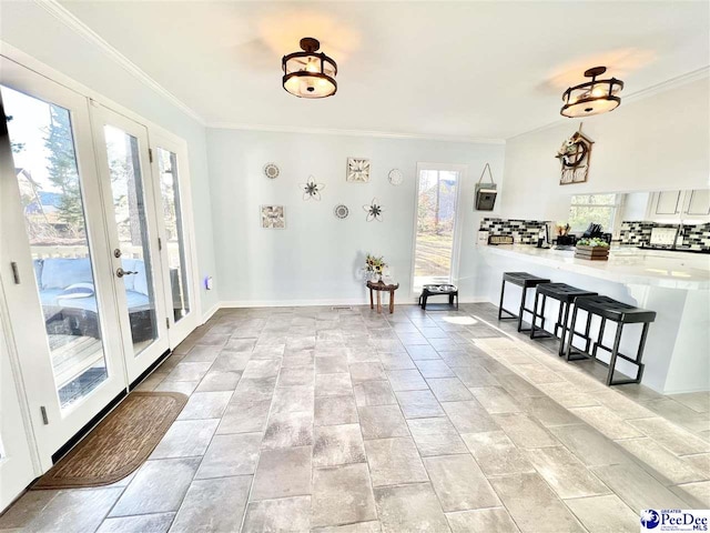 interior space featuring french doors, baseboards, and ornamental molding