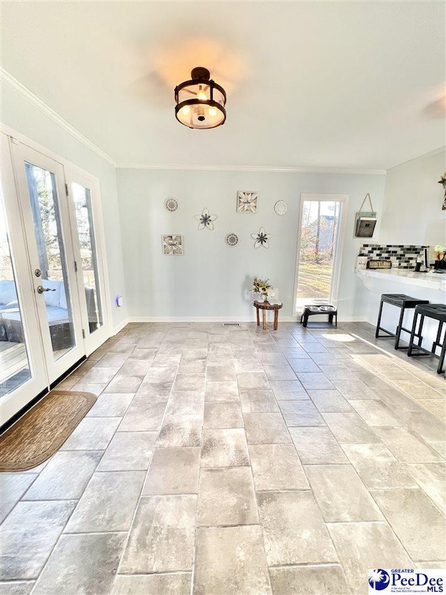 unfurnished room featuring crown molding and baseboards