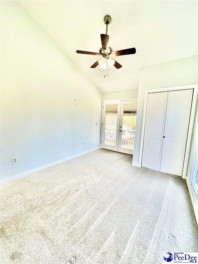 unfurnished bedroom featuring access to exterior, baseboards, carpet, vaulted ceiling, and french doors