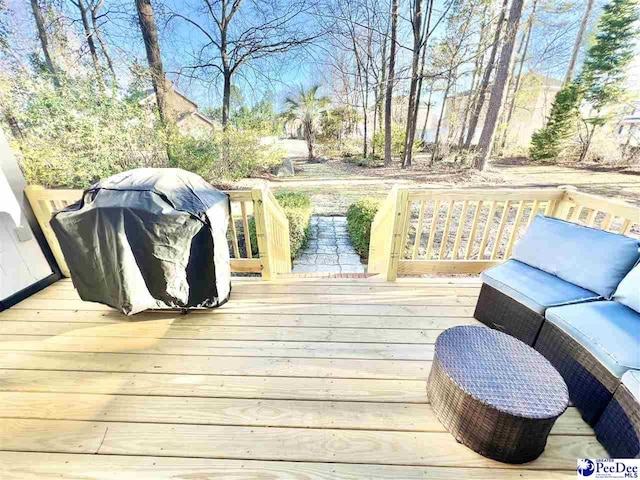 wooden deck featuring a grill