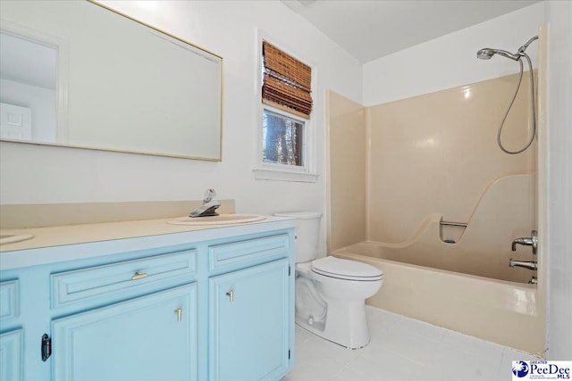 bathroom featuring tile patterned flooring, bathing tub / shower combination, vanity, and toilet