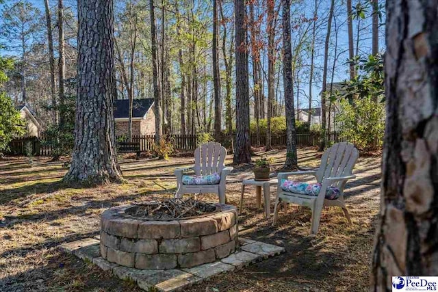 view of yard with a fire pit and fence