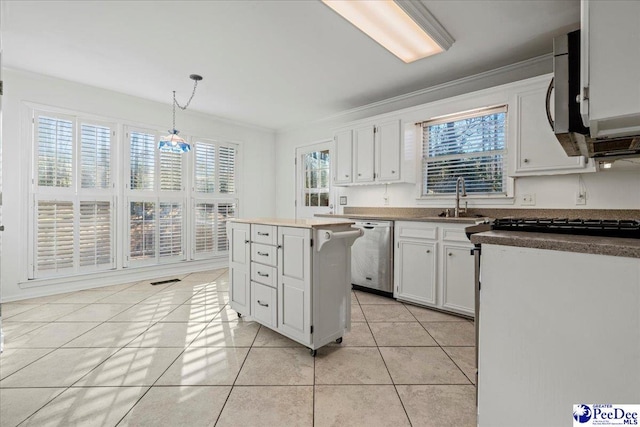 kitchen featuring light tile patterned floors, stainless steel appliances, a sink, and white cabinets