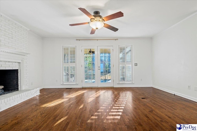 unfurnished living room featuring french doors, a fireplace, wood finished floors, and crown molding