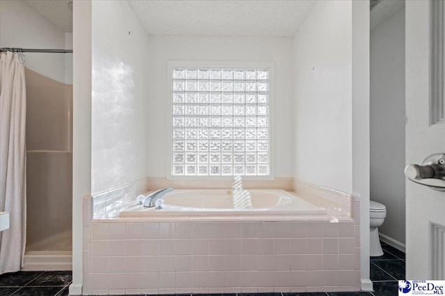 full bath featuring a stall shower, plenty of natural light, a textured ceiling, and toilet