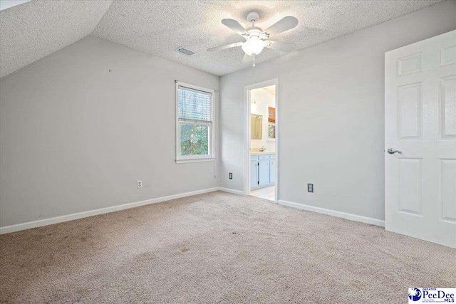 unfurnished bedroom with a textured ceiling, baseboards, visible vents, and light colored carpet