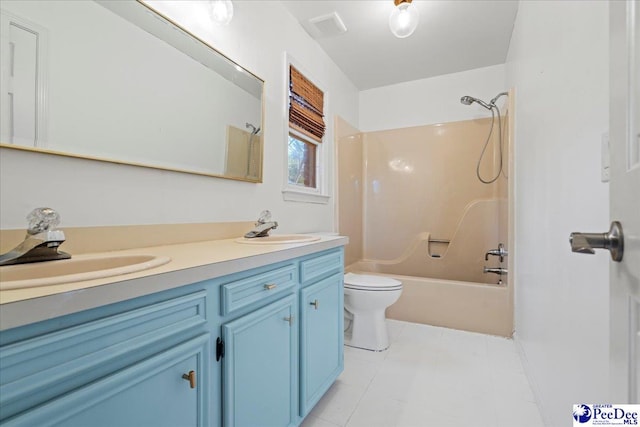 bathroom with toilet, double vanity, a sink, and shower / bathtub combination