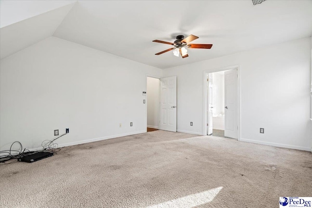 interior space featuring ensuite bath, carpet, baseboards, and a ceiling fan