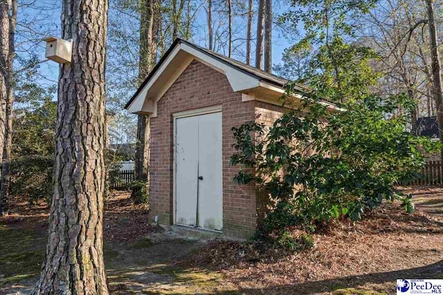 view of shed featuring fence