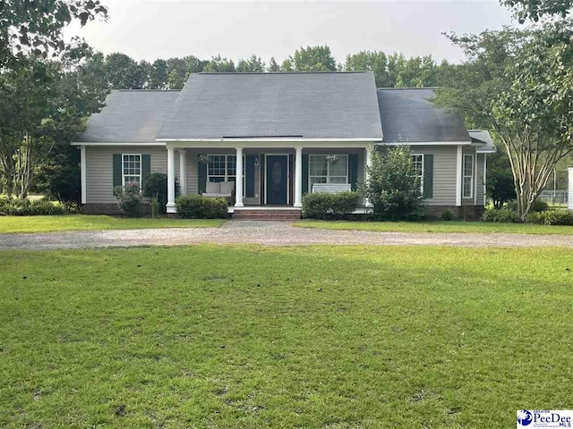 2439 Dogwood Rd, Timmonsville, SC 29161 - new england style home with covered porch and a front yard