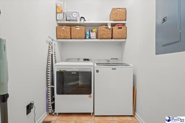 laundry room featuring separate washer and dryer, light tile patterned floors, and electric panel