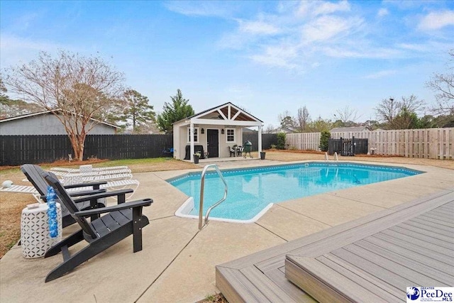 view of swimming pool featuring an outdoor structure and a patio area