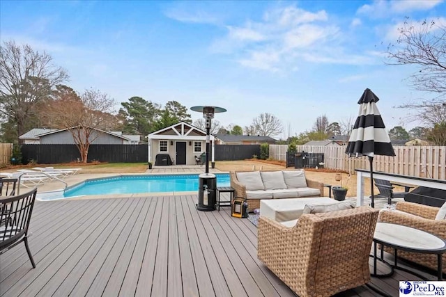 view of pool with an outdoor structure, outdoor lounge area, and a deck