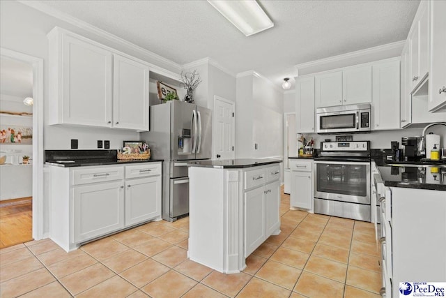 kitchen with white cabinetry, light tile patterned floors, a center island, and appliances with stainless steel finishes