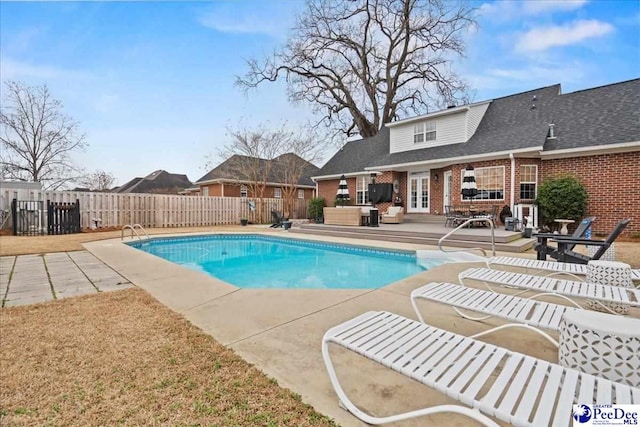 view of swimming pool featuring a wooden deck and a patio area