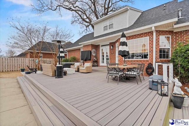 wooden deck with french doors and outdoor lounge area