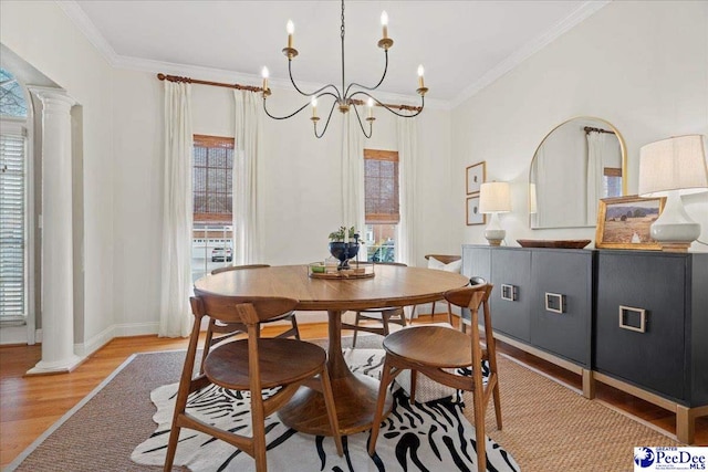 dining space featuring ornate columns, ornamental molding, and light hardwood / wood-style flooring