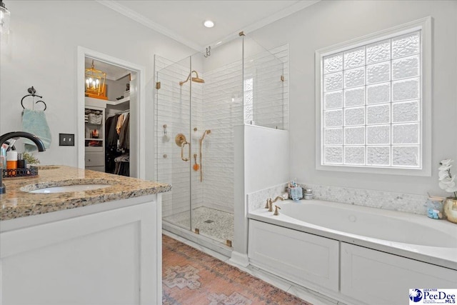 bathroom with vanity, crown molding, plenty of natural light, and plus walk in shower