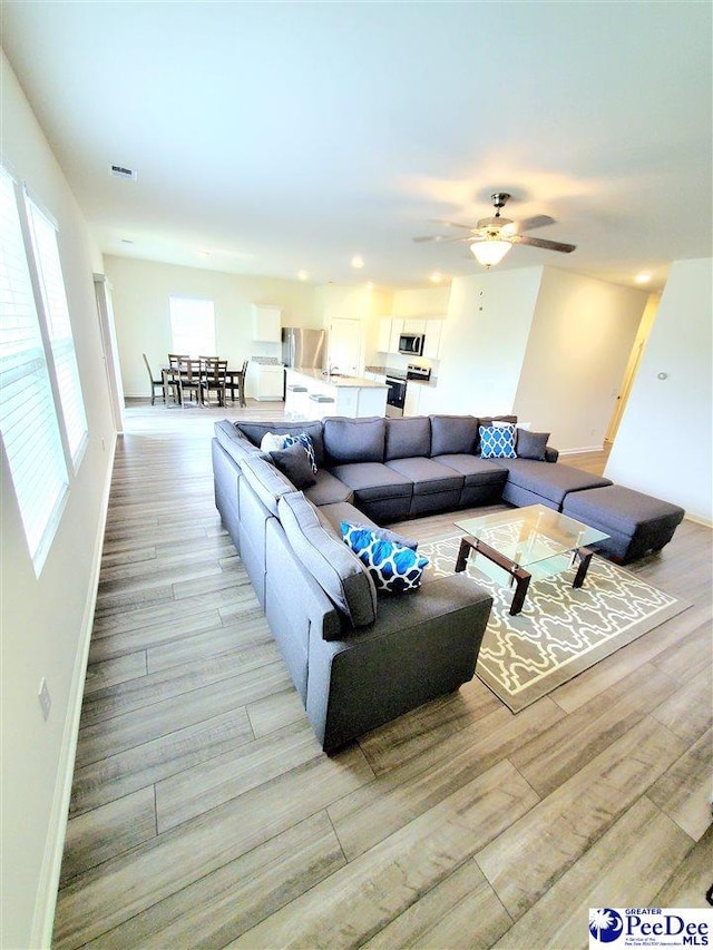 583 Polaris Way, Summerville, SC 29486 - living area featuring light wood finished floors, baseboards, and ceiling fan