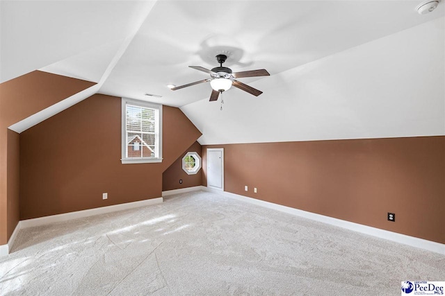 bonus room featuring ceiling fan, light carpet, and lofted ceiling