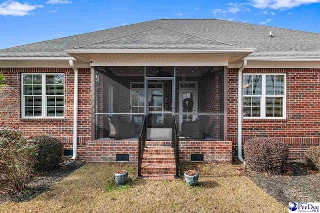 view of front of house with a front lawn and a sunroom