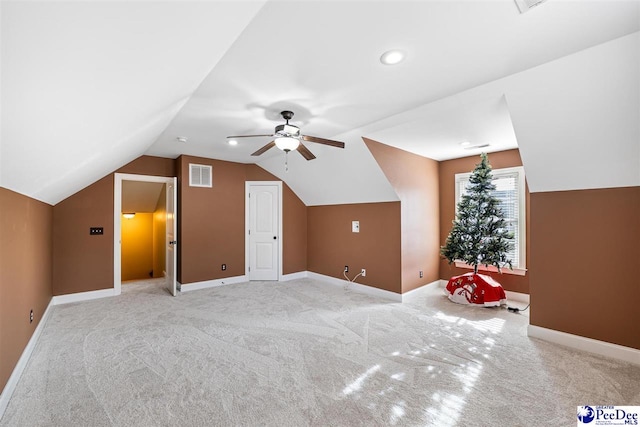 additional living space featuring light carpet, lofted ceiling, and ceiling fan