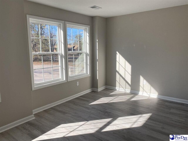 1001/1003 Jessamine Trl, Sumter, SC 29150 - spare room featuring wood finished floors, baseboards, and healthy amount of natural light